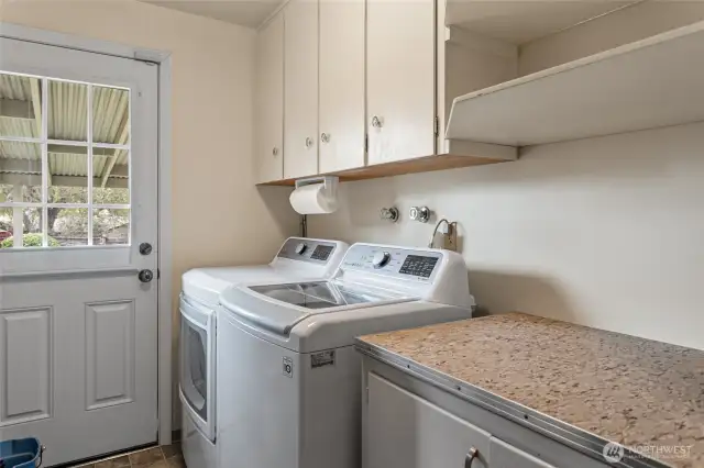 Utility room w/ backyard access and extra storage space
