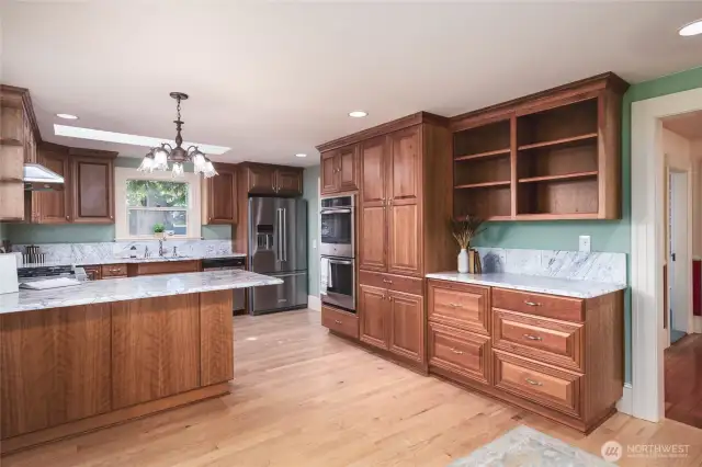 Updated kitchen with breakfast bar, tons of storage and prep space, marble counters and backsplash, pantry, double oven and tons of prep space. Invite your guests, it's time to entertain!!
