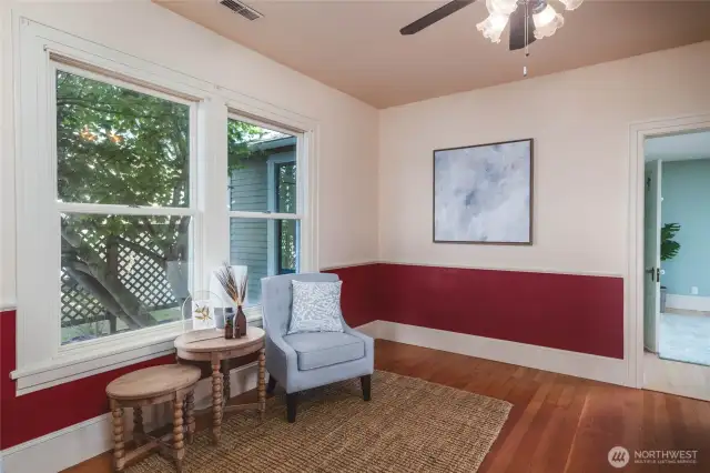 This cozy space would make a great family room, TV room, office space or lounge. You could even utilize it as a main level bedroom if needed, as there is a 3/4 bathroom on the other side of the wall with the art on it!