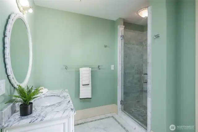 Another view of the main level bathroom with marble floors, marble vanity and shower!