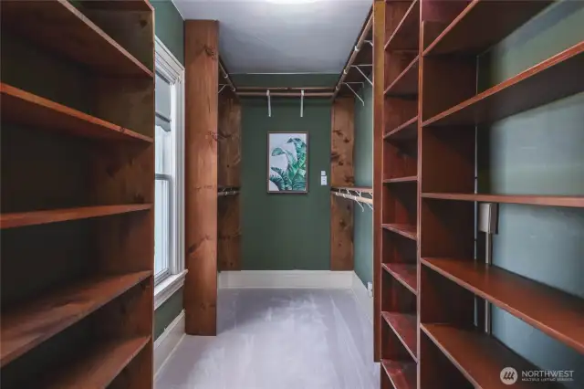 This is one of two walk-in closets. As you can see, it is quite spacious and could even be utilized as an ensuite office, sitting area, nursery or consider the possibility of creating an ensuite bathroom.