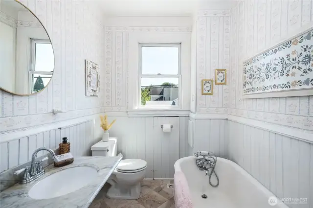 Upstairs bathroom - so lovely with marble tile flooring, tub with shower attachment...light, bright and cheery!