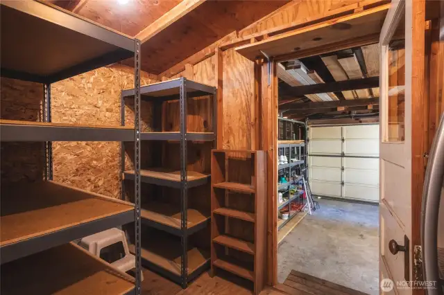 Storage room with lots of shelving and a refrigerator to keep your cold drinks!