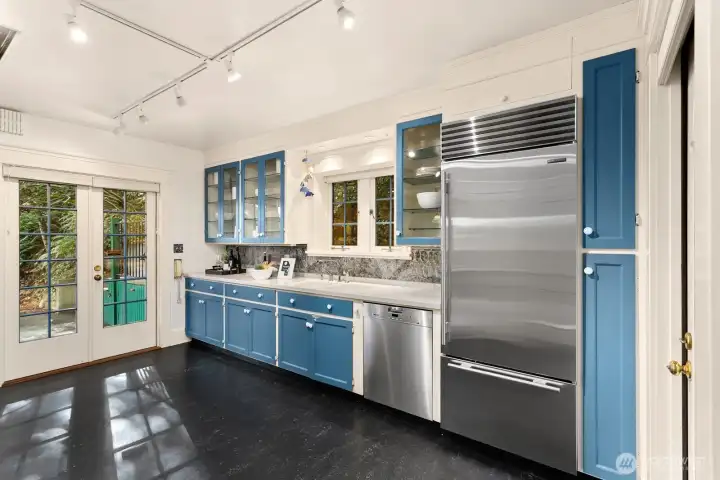 The chef’s kitchen combines timeless design and modern performance with a Miele steam oven, Gaggenau oven, Sub-Zero refrigeration, and glass-front cabinetry.  The view out the kitchen window is 100% nature!