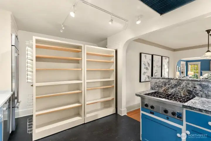 A clever design reveal: dual roll-out shelving provides generous pantry and spice storage hidden behind kitchen closet door!  Bonus in that it can immediately make your kitchen the coziest place in the house.