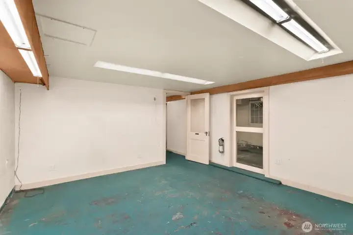 The second flexible lower-level space was used as a wood shop by the current owners.  The window here looks into the garage.