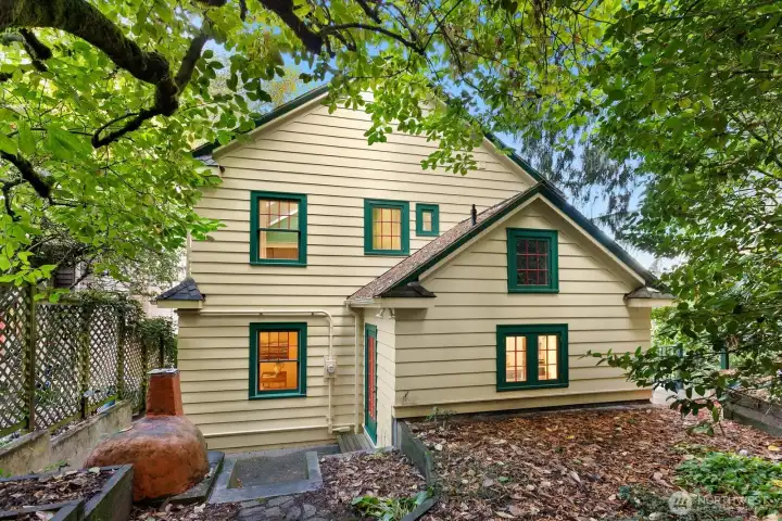 The back patio and garden features mature trees, lush ground cover, and a charming outdoor clay oven—ready for pizza nights or garden gatherings.  This is the most secluded space to enjoy.