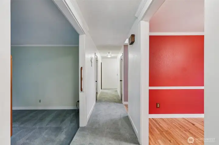Hallway facing the opposite side of the house, viewed from the kitchen and family room. To the left is the formal living room, and to the right is the dining room .