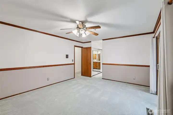 Another view of the primary bedroom with ensuite bathroom.