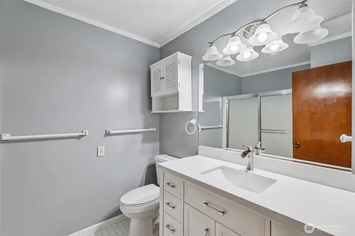 Hallway bathroom with bathtub and a new vanity.