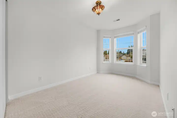 Additional upstairs bedroom with bay window.