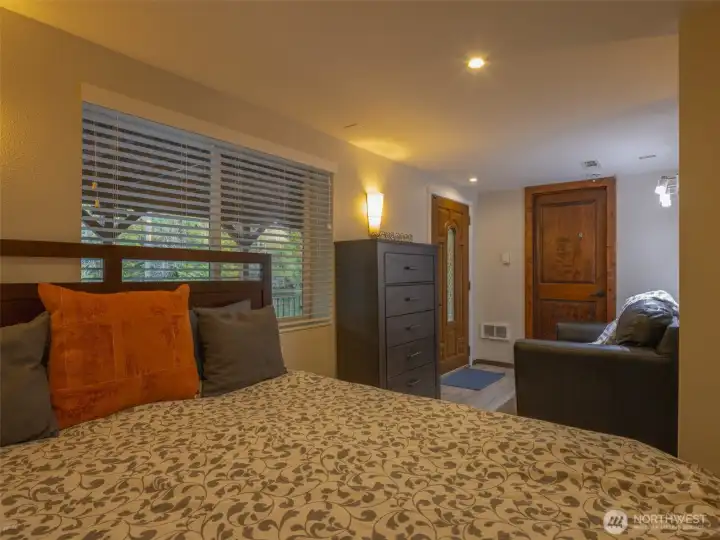 A well appointed primary bedroom that has convenient access to the outside covered patio with a water view at high tide