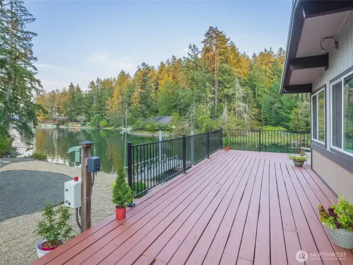 Fabulous wrap around deck for entertaining or to just hang out with lush greenery and water views, and amazing sunsets