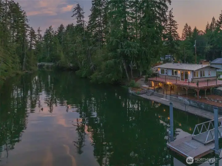 Watch stunning sunsets from your spacious deck, look how private this home is with the water and trees