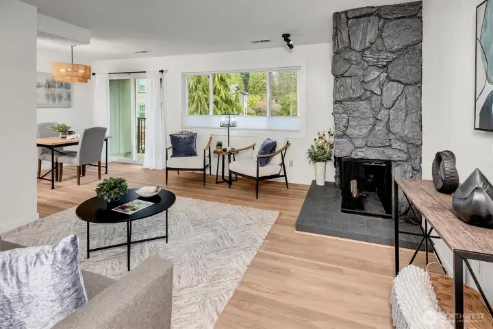 Wonderfully updated with new LVP flooring, fresh interior paint and stone woodburning fireplace.  Sliding glass door and large living room window provide lovely natural light.