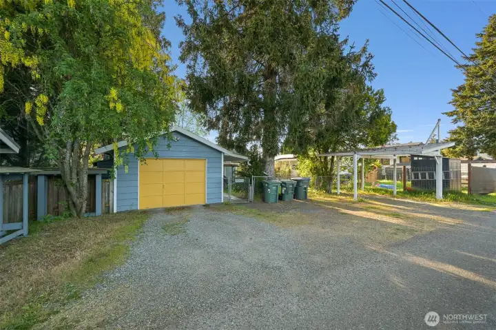 Oversized one car garage with work bench and ample storage space.