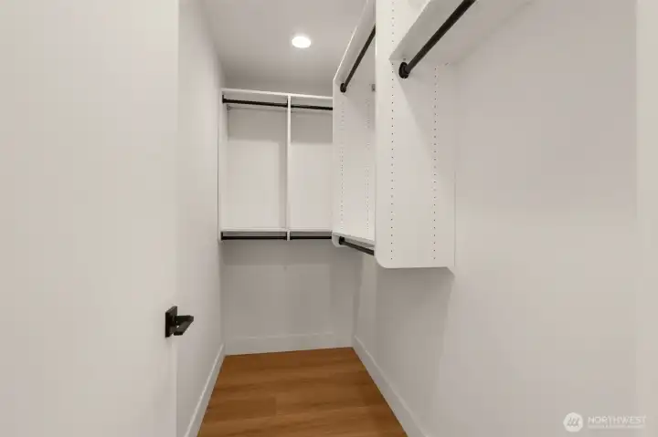 Primary bedroom walk in closet