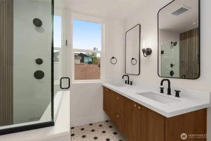 Double vanity and stylish tile work in primary bathroom.