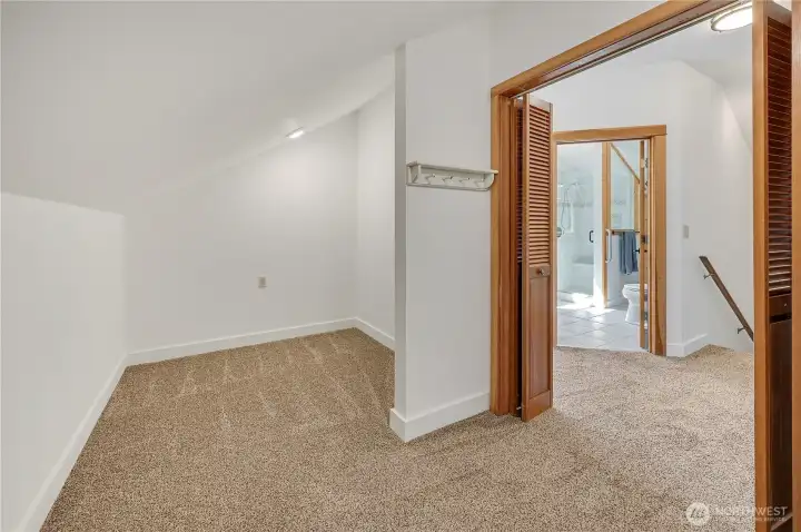 Large walk-in closet upstairs with door to 3/4 bath & primary bedroom to the right.