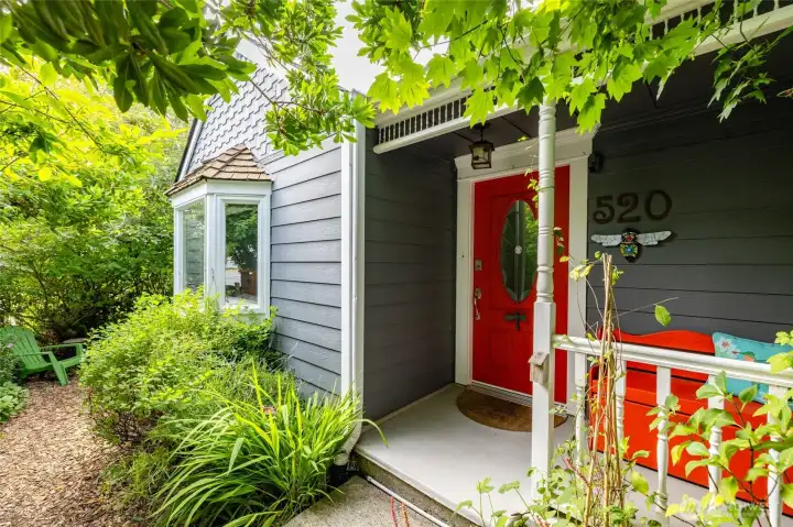 Welcoming front porch and garden window to take in the enchanting gardens.