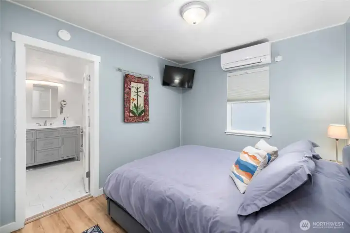 Primary bedroom with LVP floors, minisplit, fresh paint and it's own ensuite bathroom!