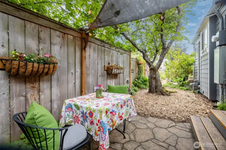 Private outdoor patio space tucked in the garden and protected by a 7' fence perfect for enjoying your morning coffee or an evening cocktail!