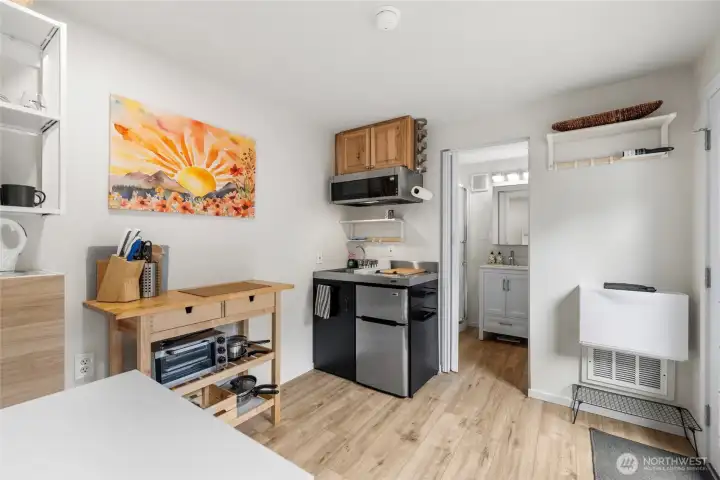 Well designed 1 bedroom ADU offers kitchenette with frig, cooktop, microwave, storage, eating and prep space, it's own washer/dryer and 3/4 bathroom.  LVP flooring and heat/AC.
