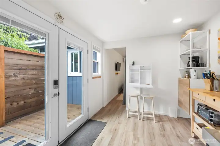 French doors lead onto a private deck and garden entry to the 1 bedroom, fully equipped ADU with kitchenette, eating and prep space, 3/4 bath and it's own laundry. LVP flooring and heat/AC (minisplit).