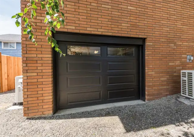 Lower level single car garage, with workshop/storage room