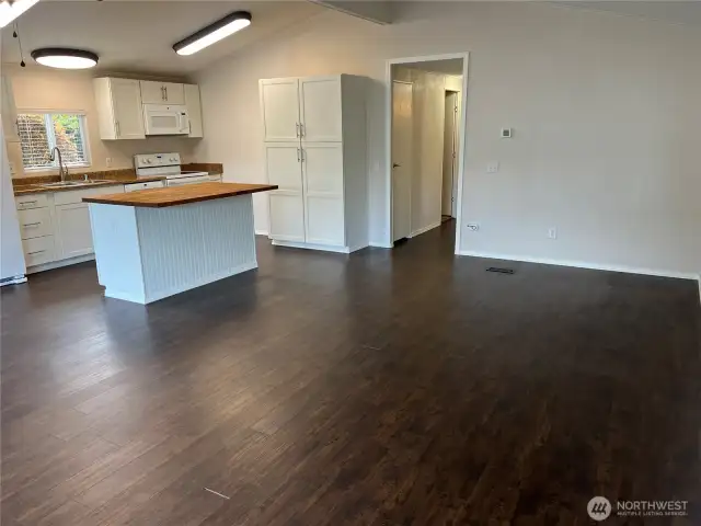 View of dining area and kitchen from living area.