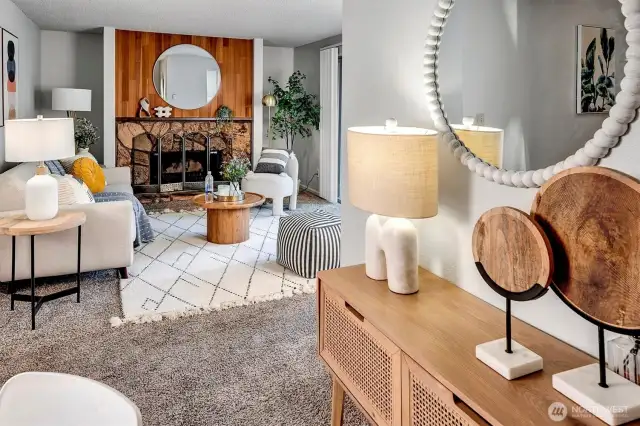 A cozy wood burning fireplace anchors the open Living and Dining rooms.