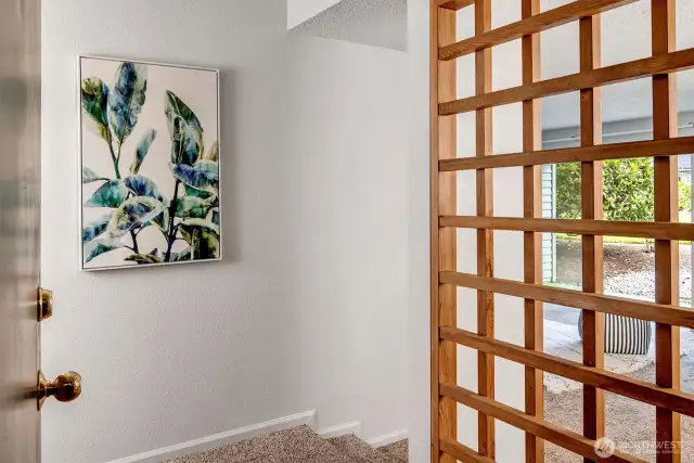 Welcoming entry with wood screen buffer between the entry and main living areas