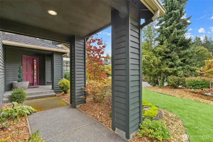 LOVELY FRONT PORCH WITH ROOM FOR PATIO FURNITURE AND FLOWERPOTS.