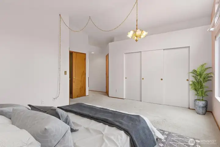 RELAXING PRIMARY BEDROOM UPSTAIRS W/ VAULTED CEILINGS & ACCESS TO A LARGE WALK-IN CLOSET & EN-SUITE FULL BATHROOM.