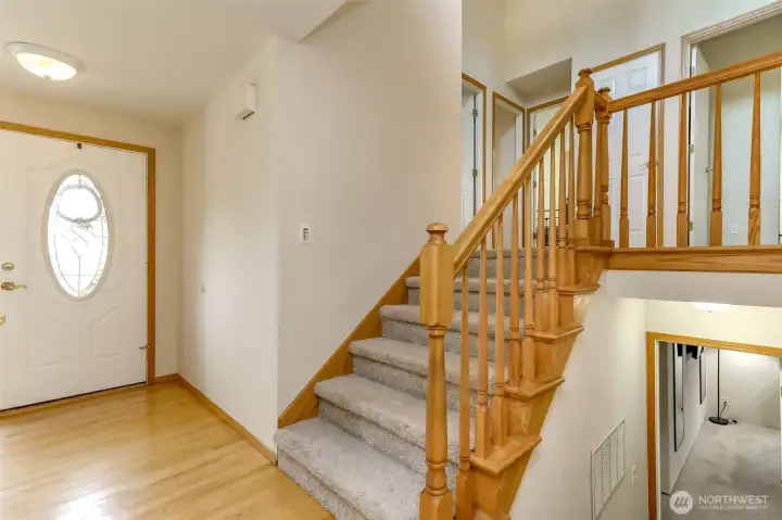 The light and bright formal foyer entry has hardwood floors.