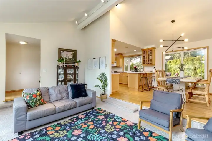 The formal living room has vaulted ceilings with overhead lighting and a gas fireplace.