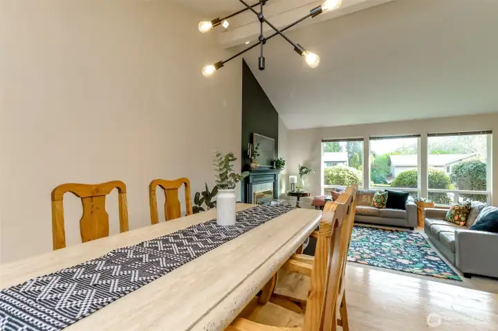 The formal dining room is open to the living room and there are views to the west and to the east outside the windows.
