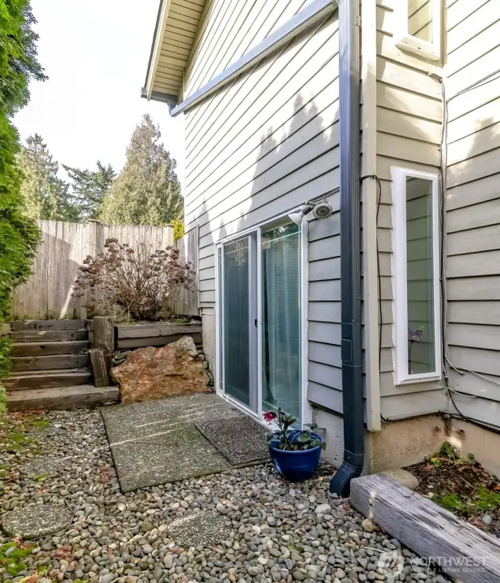The side yard along the garage has a gravel path with stepping stones leading to the side patio and door to enter the lower level rec room which would be perfect to convert to an apartment or a second suite.