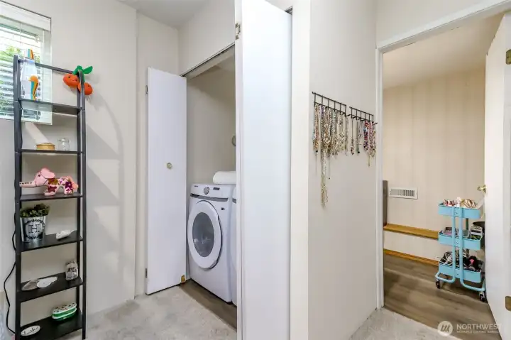 There is a half bath on the ground level next to the rec room and it would be easy to add a third shower.  The laundry closet is also on this ground level and with the amount of space in the garage, you could move the laundry equipment into the garage.