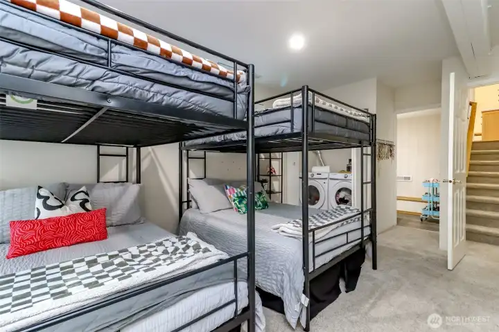 Here is another view of the ground level rec room with the 1/2 bathroom and laundry closet pictured behind the bunk beds.