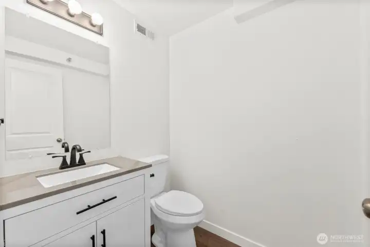 Updated Powder Room Half Bath on Main - Stone Top Vanity & LVP Floor.