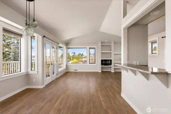 Turning left from the foyer you enter the dining area, with passthrough to the kitchen on the right. The bartop is perfect for a couple of barstools