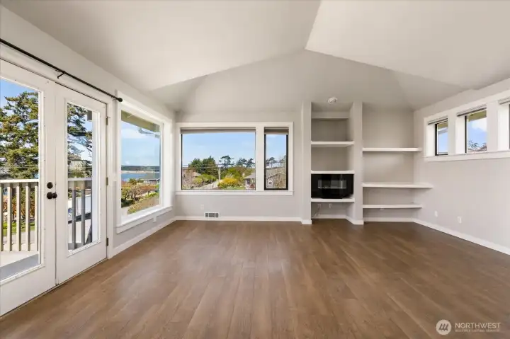 This central part of the living room, with its vaulted ceiling, provides plenty of room for entertaining, especially with the glorious views and french doors to the deck