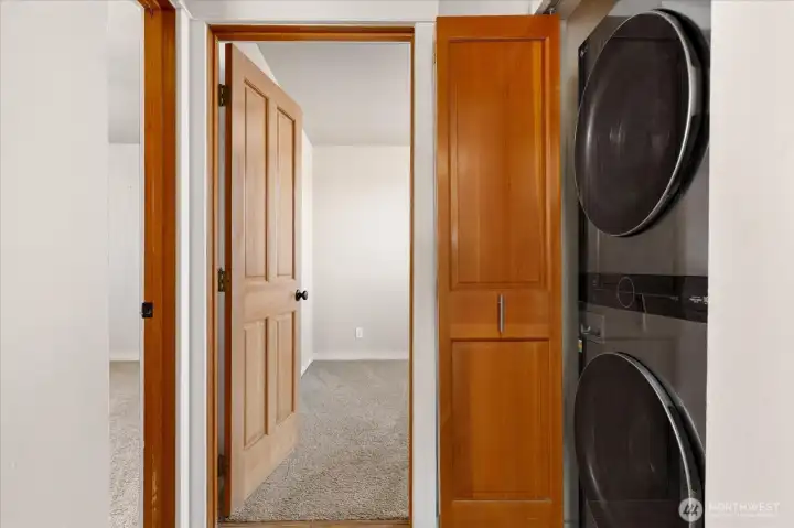 The hallway contains the laundry closet, with room for a full size stacked unit.