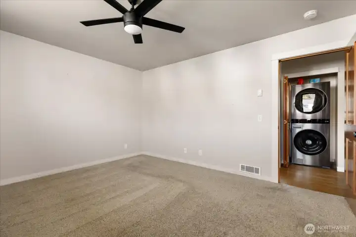 Looking from primary back to hallway and laundry closet.