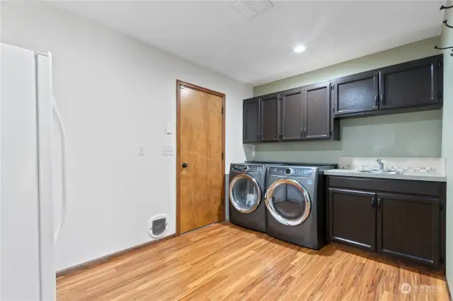 Dedicated laundry space also serves as mudroom entrance to garage and pantry.