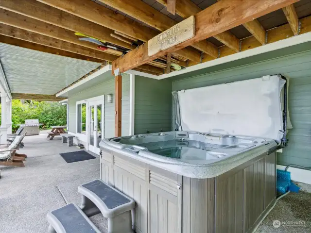 Covered Sundance hot tub with convenient access to house and beach
