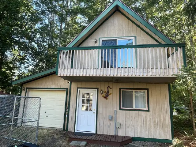 This cute guest house has a living room and kitchen on the main floor with laundry, 3/4 bath, sitting area, bedroom and private deck above. The garage has been split into exterior access storage and interior access storage. Electric car charger is located here.