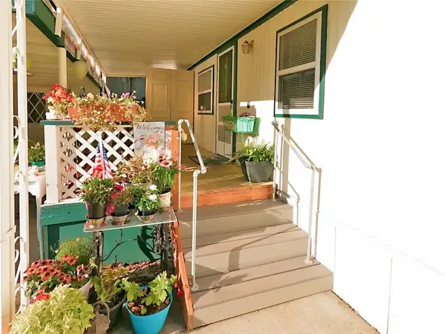 Front porch with storage cabinet in the back.