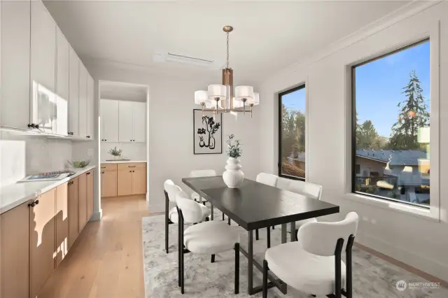 Formal dining space overflowing with natural light and beautiful custom built-in cabinetry.